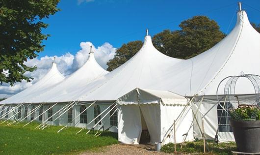 a line of portable restrooms in a shaded area, offering a comfortable experience for users in Coram